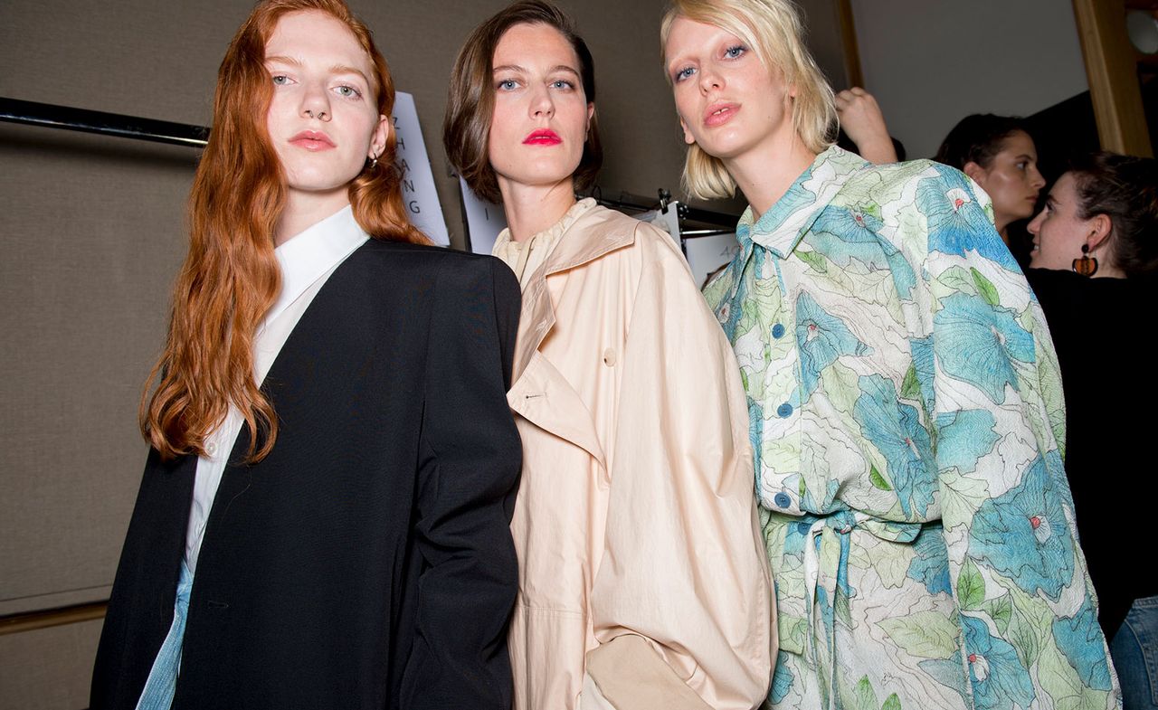 Models wear white shirt with black blazer, beige jacket and blue and white floral dress