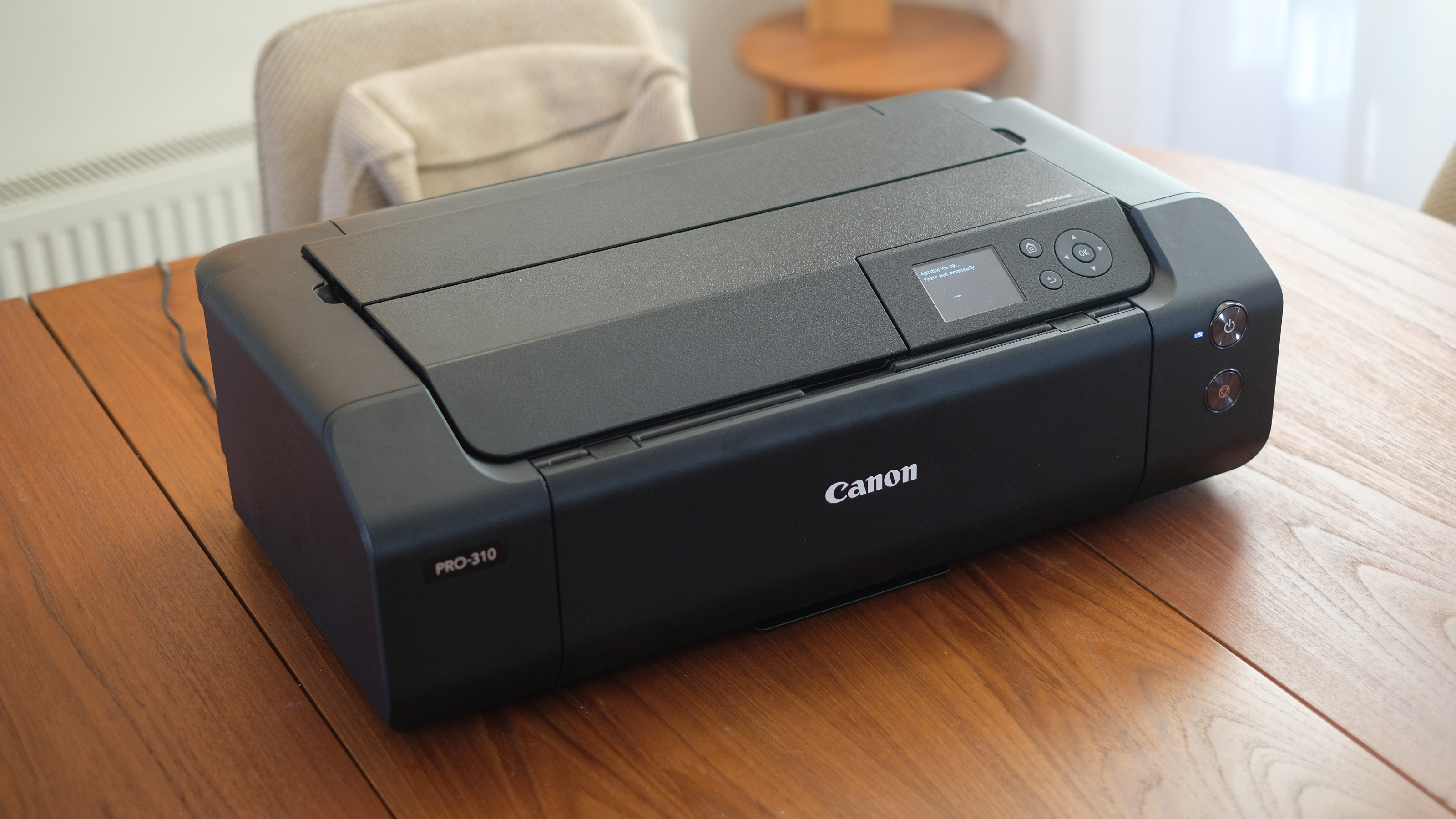 A photograph of the Canon imagePROGRAF PRO-310 printer folded on a table