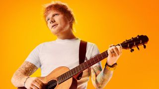 Ed Sheeran holding a guitar on an orange background