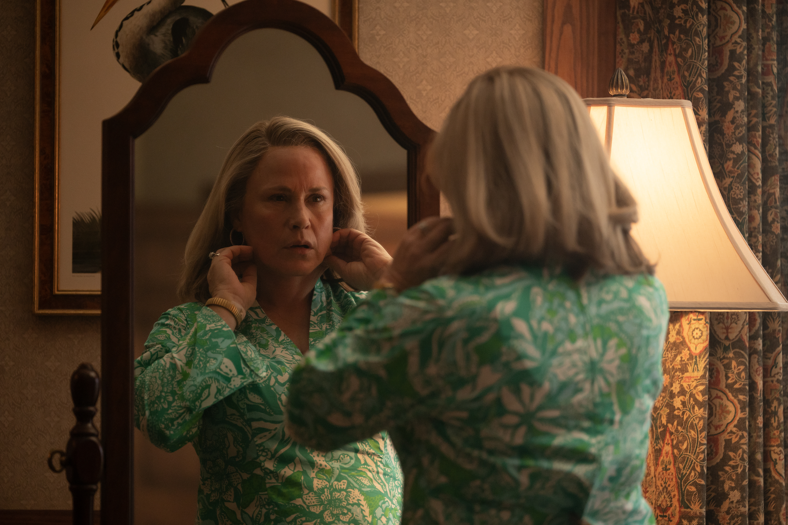 Patricia Arquette as Maggie Murdaugh looking at her hair in the mirror in murdaugh a death in the family