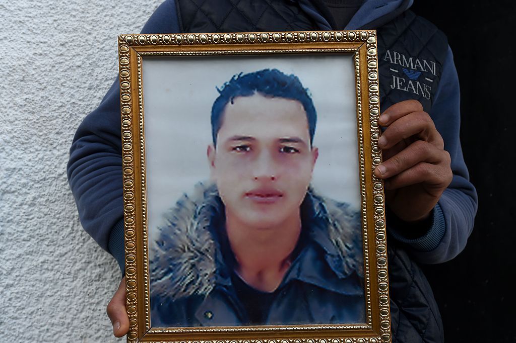 Anis Amri&amp;#039;s brother holds his portrait