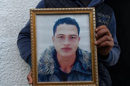 Anis Amri's brother holds his portrait