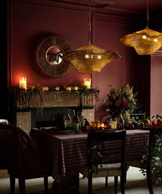 burgundy dining room decorated for christmas with candles and twinkling lights