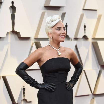 Lady Gaga on the red carpet of the Academy Awards in a black gown and diamonds