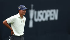 George Duangmanee waits in front of a US Open leaderboard