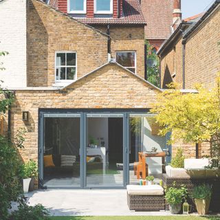 Single storey rear kitchen extension built with brick and incorporating sliding doors onto the garden patio