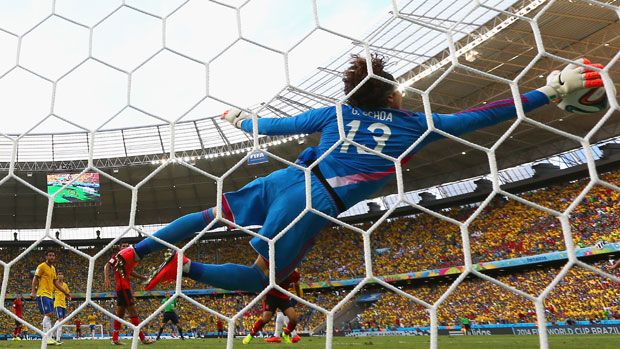 Goalkeeper Guillermo Ochoa of Mexico dives to make a save 