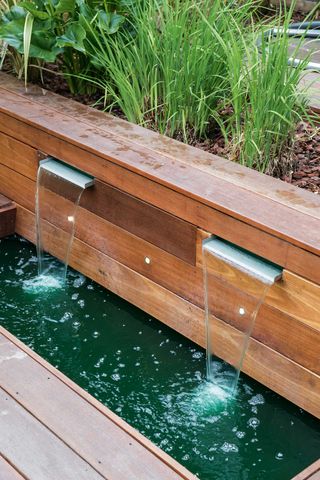 garden pond ideas: waterfall into pond with wooden edging