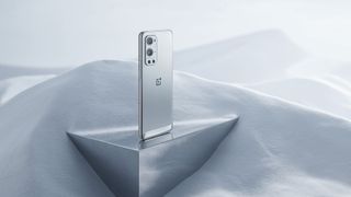 OnePlus 9 Pro displayed on a mirrored surface