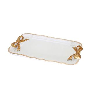 A white trinket tray with gold trimming