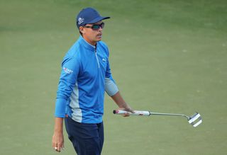 Rickie Fowler walks with his putter in hand