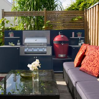 EO outdoor kitchen area with BBQ and cushioned seats