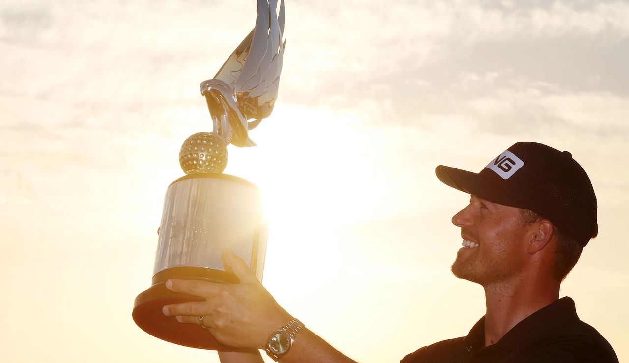 Perez holds up the trophy to the sky