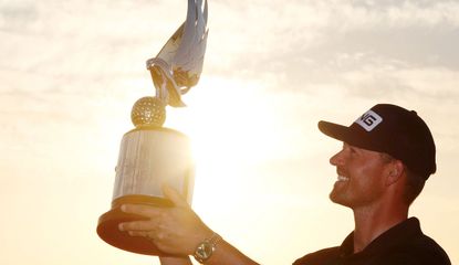 Perez holds up the trophy to the sky