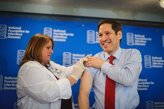 Dr. Thomas Frieden, director of the Centers for Disease Control and Prevention, receives a flu shot