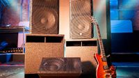 A brown electric guitar leaning against Yamaha's new loudspeaker series. 