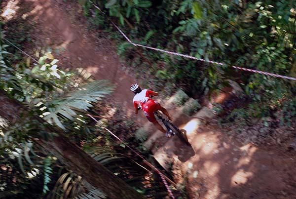 A woman rides a downhill.
