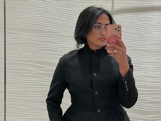 chiara takes mirror selfie and wears black blazer with a cinched waist