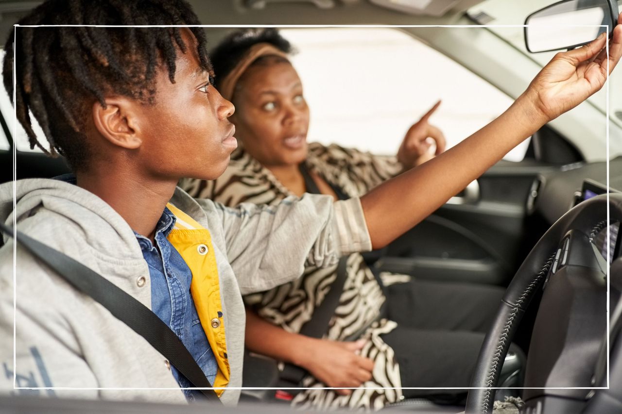 Teen driver checking rearview mirror while mum teaches him how to drive