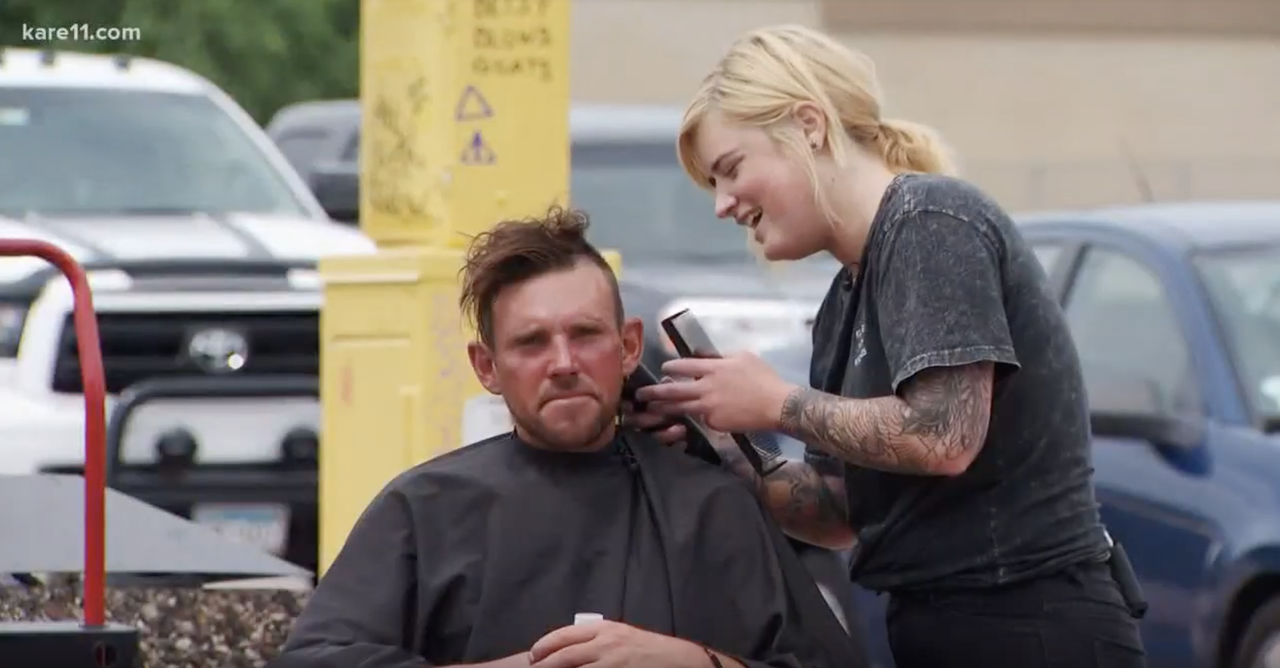 Katie Stellar provides a man with a free haircut.