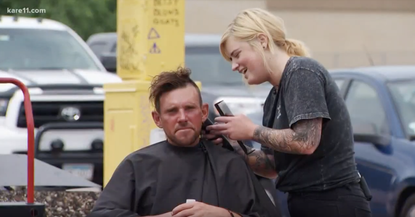 Katie Stellar provides a man with a free haircut.