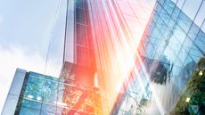 A view looking up at skyscrapers that makes them appear sunrise bright.