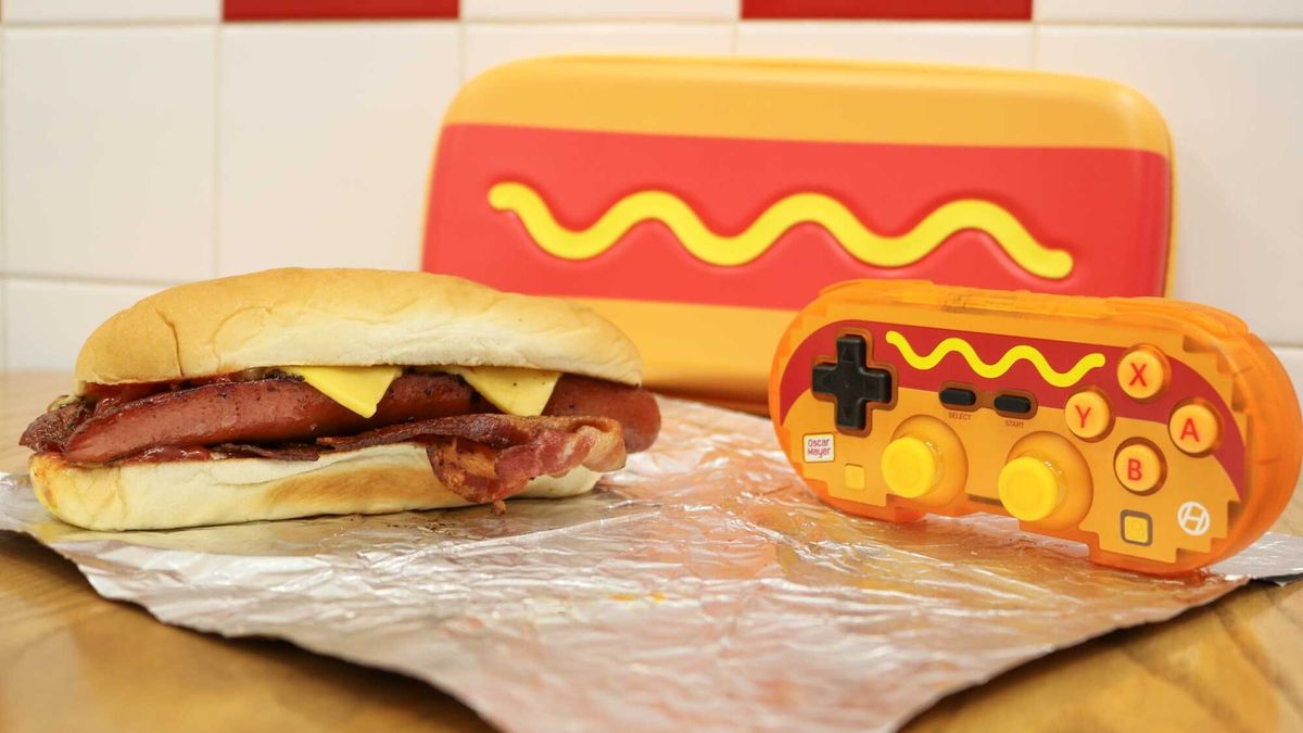 The Hyperkin Pixel Art Hot Dog controller next to its matching case and a real hot dog