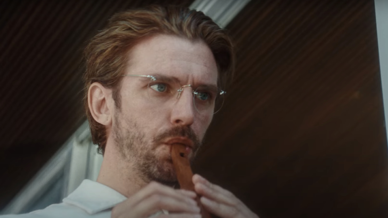 Dan Stevens as Herr Konig playing the flute in Cuckoo