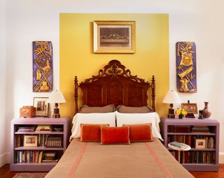 Wooden bed, yellow wall section behind bed