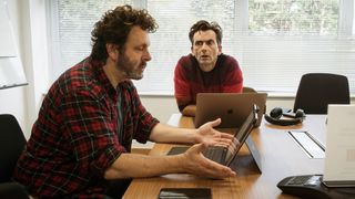 Michael Sheen and David Tennant sitting in front of laptops in Staged season 3