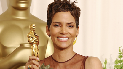 Halle Berry poses with her Actress in a Leading Role Oscar for &quot;Monster&#039;s Ball&quot; at the 2002 award show, wearing a maroon naked dress from Elie Saab