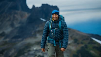 best walking trousers: A man out hiking in walking trousers and jacket