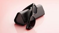 The Meta glasses with a case on a peach background