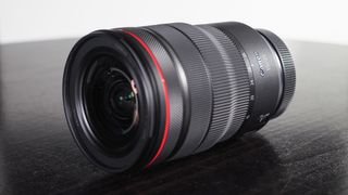 Photograph of Canon RF 15-35mm f/2.8L IS USM on black wood surface