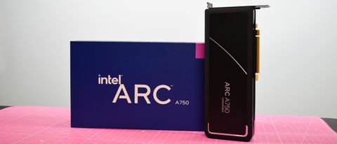 An Intel Arc A750 graphics card on a pink desk mat next to its retain packaging