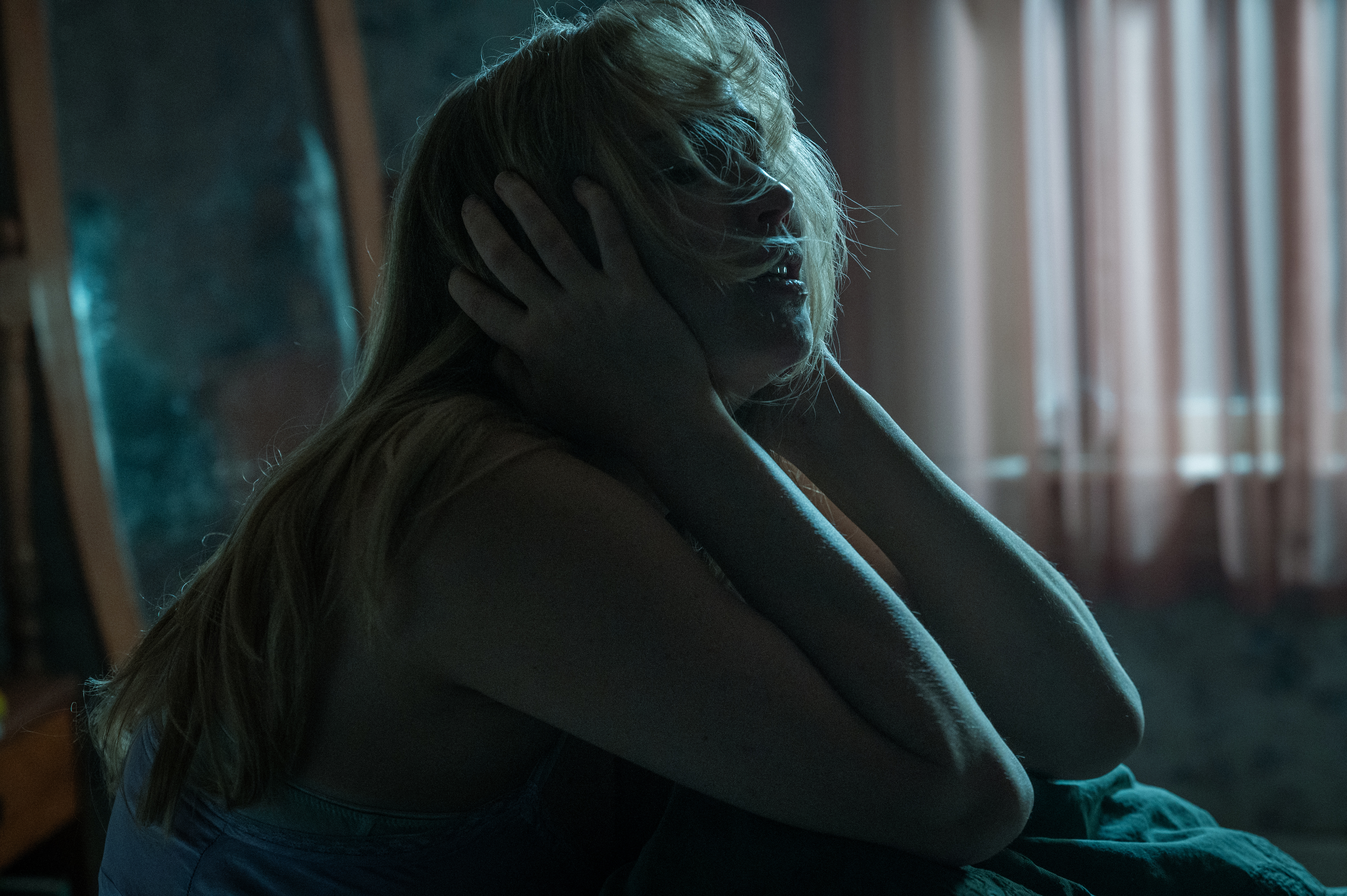 jennifer lawrence in die my love looking like she's in agony in bed at night time