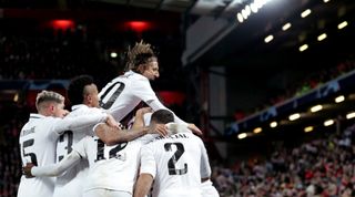 Real Madrid's players celebrate after Karim Benzema scored their side's fifth goal during the UEFA Champions League last 16 first leg match between Liverpool and Real Madrid at Anfield on 21 February, 2023 in Liverpool, United Kingdom.