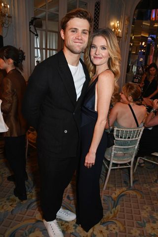 The White Lotus co-stars Meghann Fahy and Leo Woodall smile together at an event