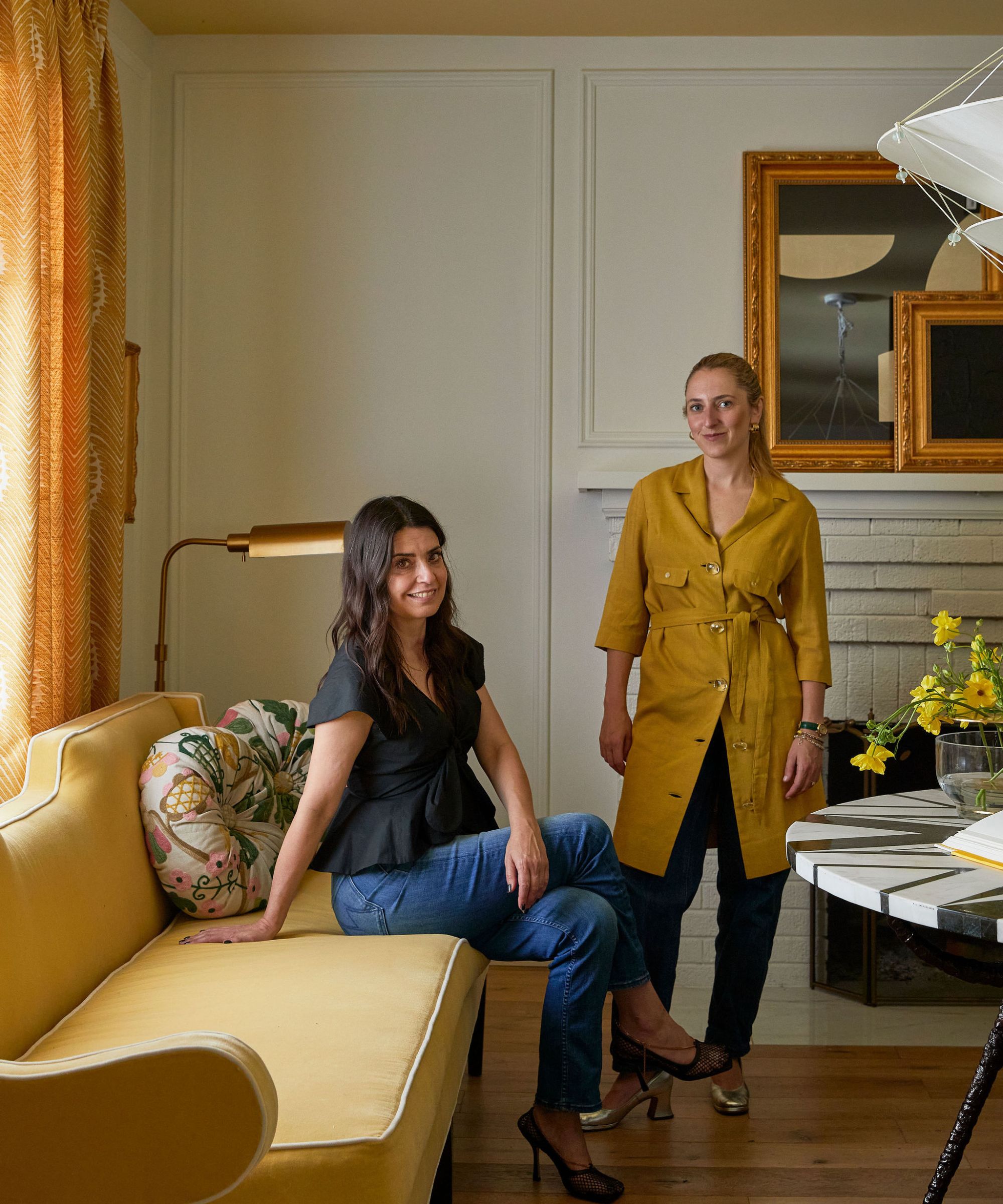 Designer Daniella Dolman and her mother in her yellow dining room