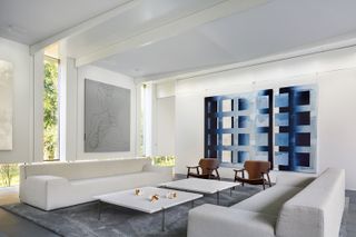 minimalist living room with large blue art on the wall