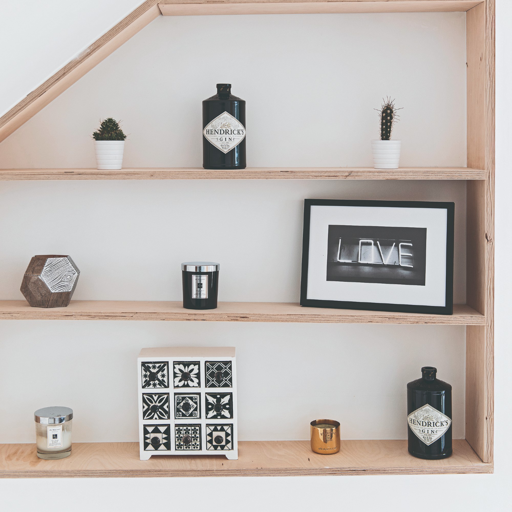 Shelves with arranged decorative items and two Jo Malone scented candles