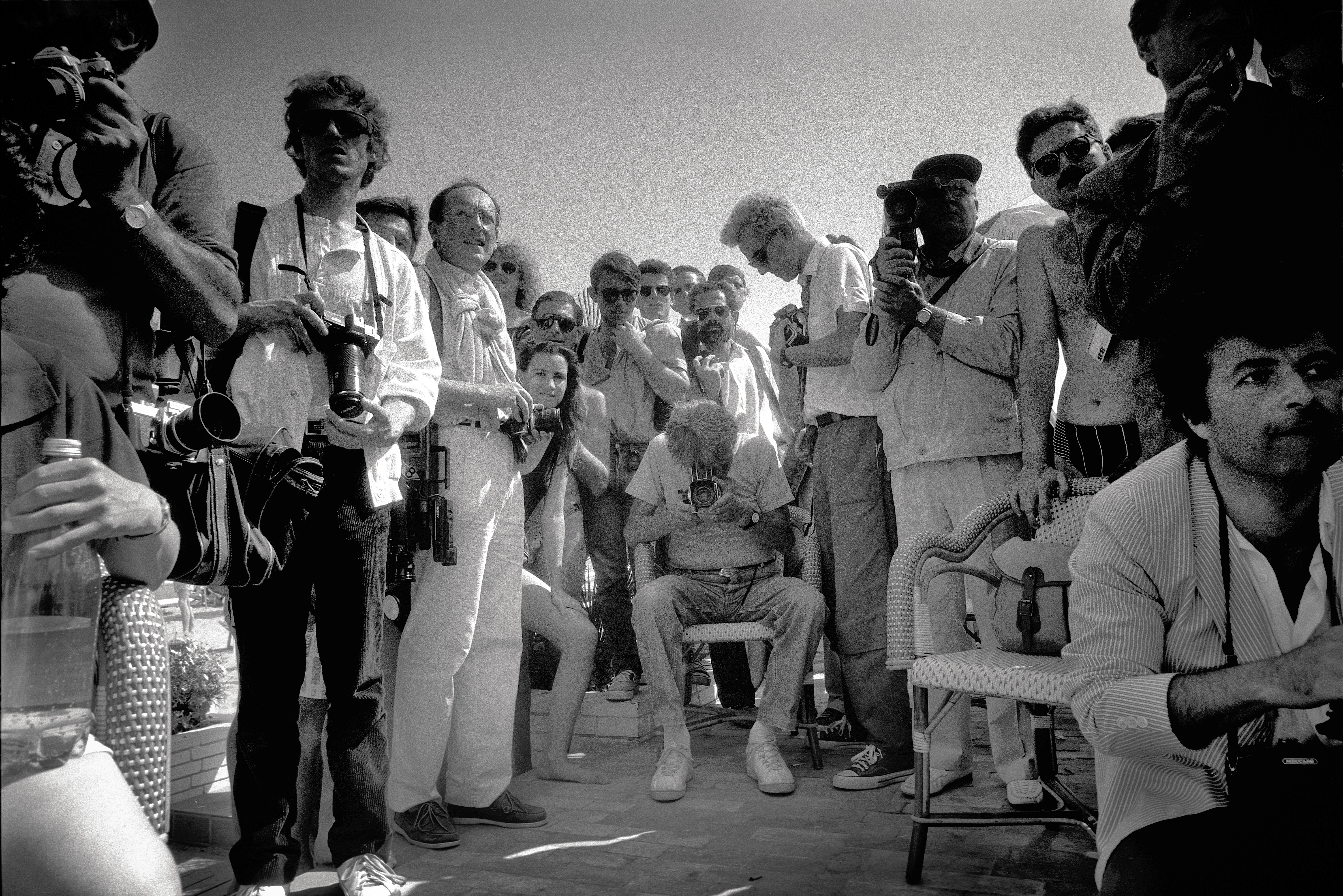 Helmut Newton taking a picture, amid Cannes crowd