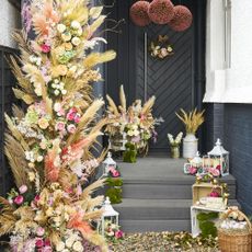 house with grey steps and floral doorscape decorations