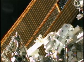 Spacewalkers work near International Space Station's Solar Arrays