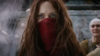 A masked Hera Hilmar stands staring at something with concern in Mortal Engines.