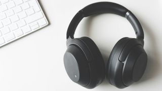 Image of a pair of headphones next to a keyboard