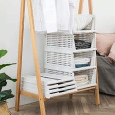 Perome wardrobe storage box in bedroom containing folded linen