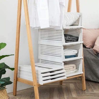 Perome wardrobe storage box in bedroom containing folded linen