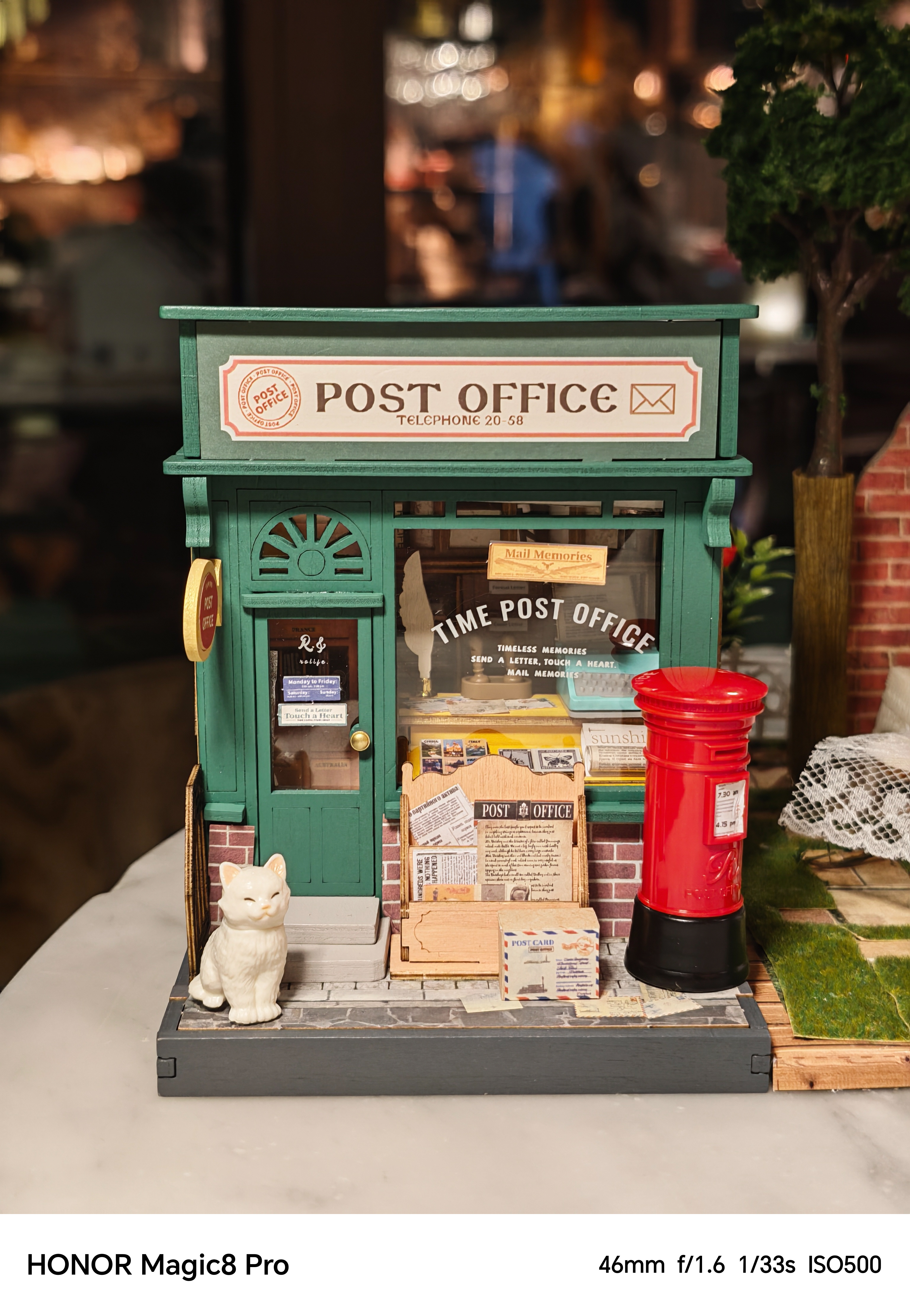 A miniature model of a post office shot on an Honor Magic 8 Pro