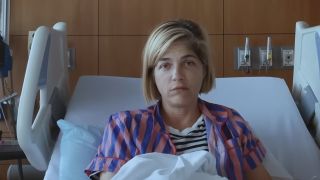 Selma Blair with blonde hair, being interviewed from her hospital bed in Introducing, Selma Blair